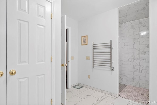 bathroom featuring a tile shower and radiator