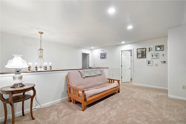 sitting room featuring light carpet and a chandelier