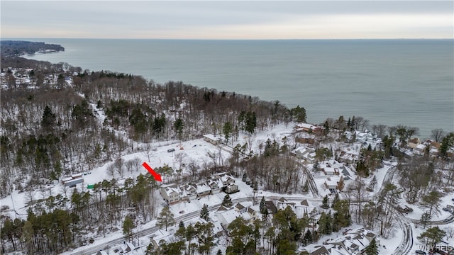 snowy aerial view featuring a water view