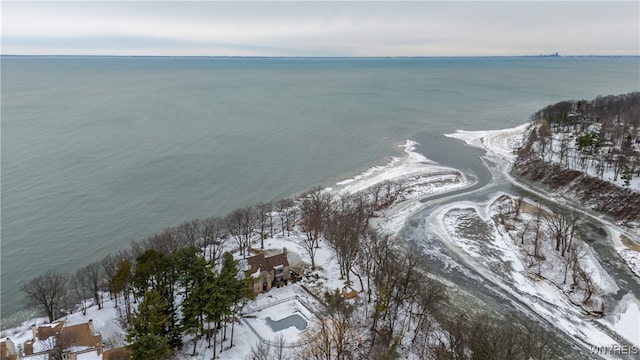 snowy aerial view with a water view