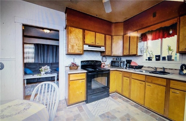 kitchen featuring tasteful backsplash, black / electric stove, ceiling fan, and sink