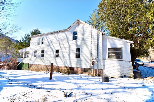 view of snow covered rear of property