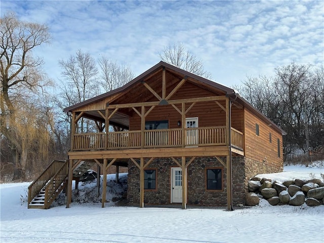 snow covered house with a deck