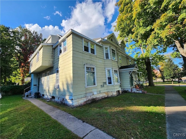 view of home's exterior with a yard