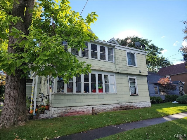 view of side of property with a yard