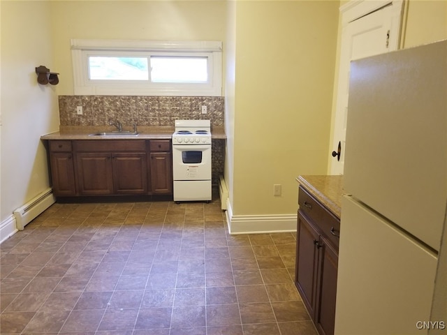 kitchen with dark brown cabinetry, sink, baseboard heating, backsplash, and white appliances