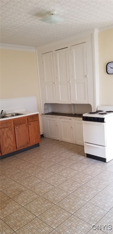 kitchen with white range oven, crown molding, sink, and a textured ceiling