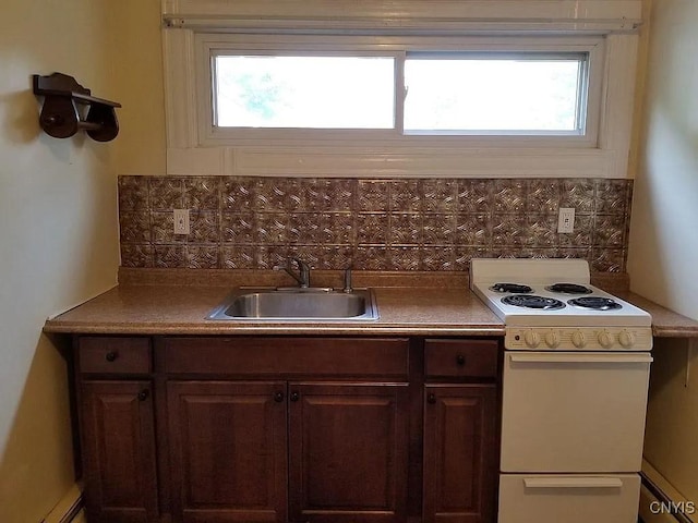 kitchen with white range with electric stovetop, a wealth of natural light, decorative backsplash, and sink