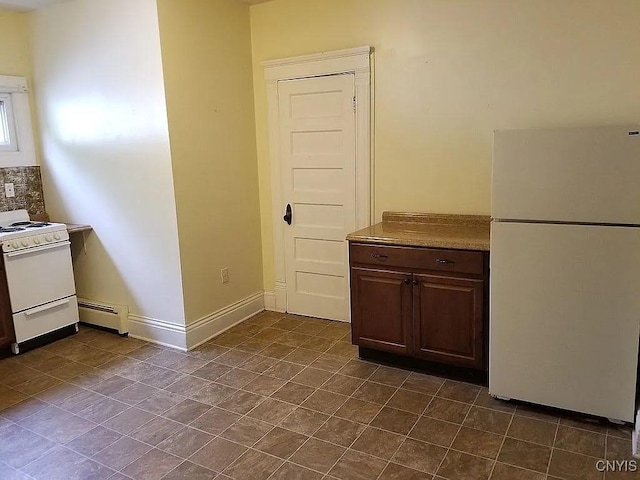 kitchen featuring dark brown cabinets, a baseboard radiator, and white appliances