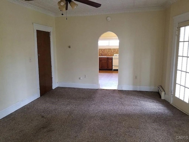 carpeted spare room featuring baseboard heating and ceiling fan