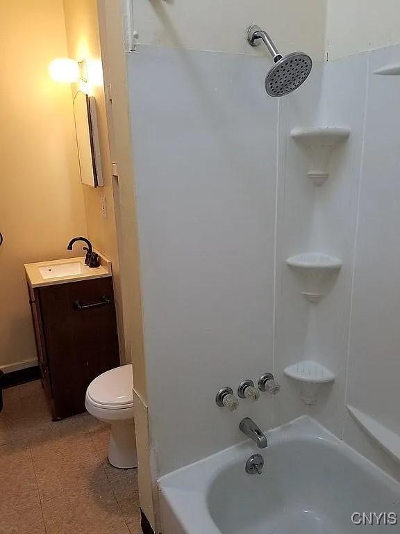 full bathroom with vanity, toilet, and  shower combination