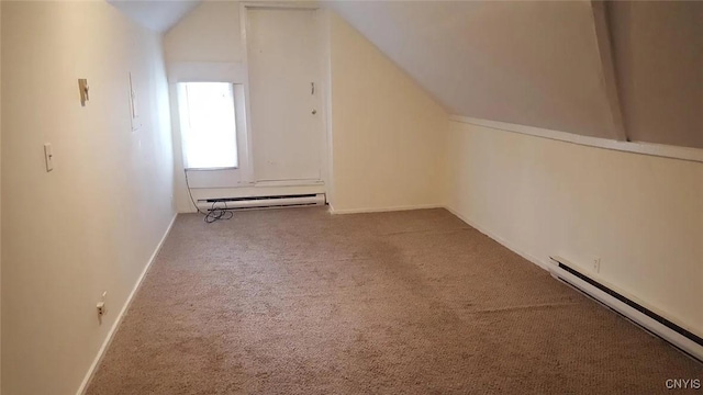 additional living space with carpet, lofted ceiling, and a baseboard heating unit