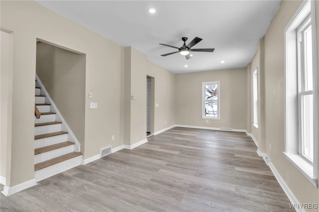 empty room featuring ceiling fan and light hardwood / wood-style flooring