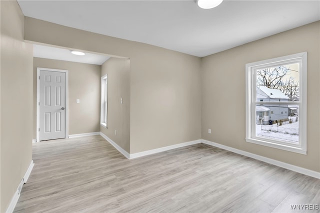 unfurnished room with light wood-type flooring