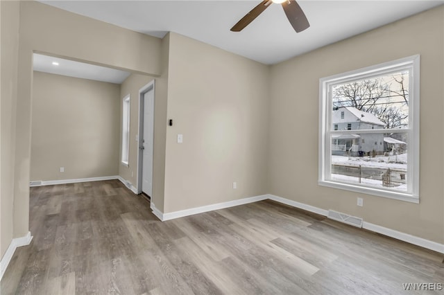 spare room with ceiling fan and light hardwood / wood-style flooring