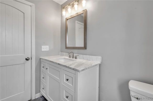 bathroom featuring vanity and toilet