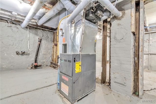 utility room featuring heating unit