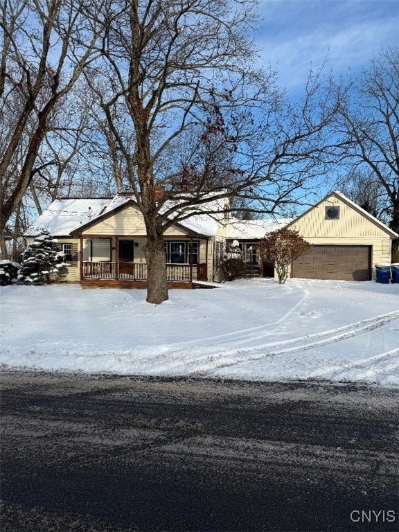 view of front facade featuring covered porch and a garage