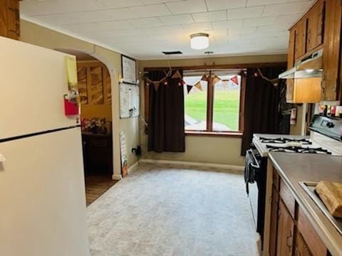 kitchen featuring white fridge and stove