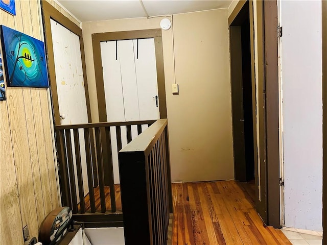 corridor featuring wood walls and wood-type flooring