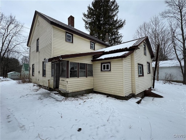 view of snow covered rear of property