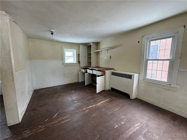 kitchen featuring butcher block countertops, dark hardwood / wood-style flooring, and radiator