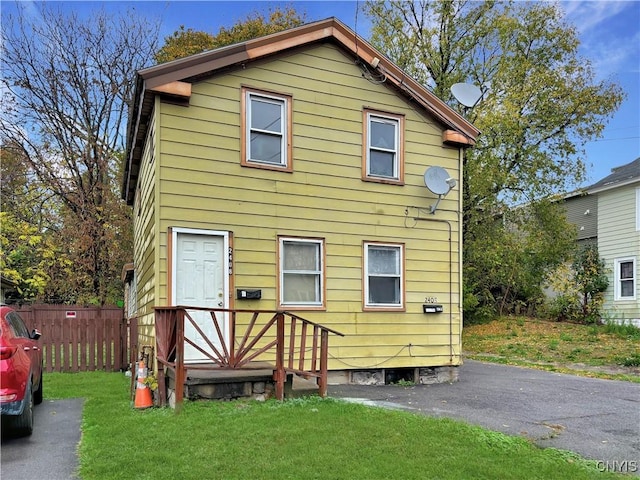 rear view of house featuring a yard