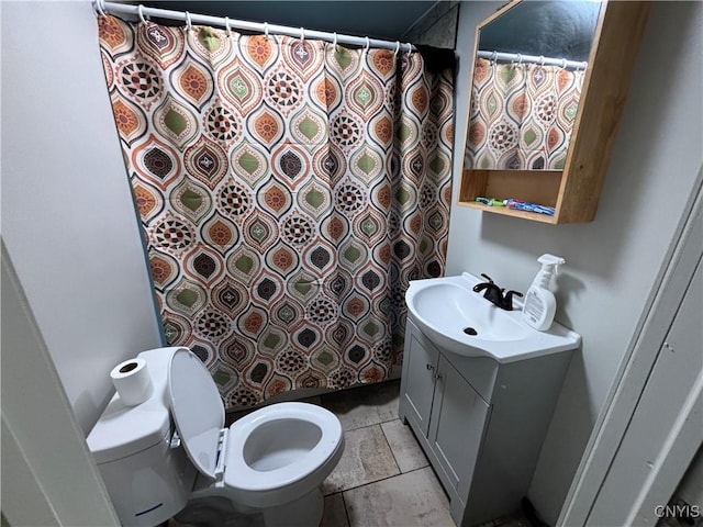 bathroom with vanity, toilet, and curtained shower