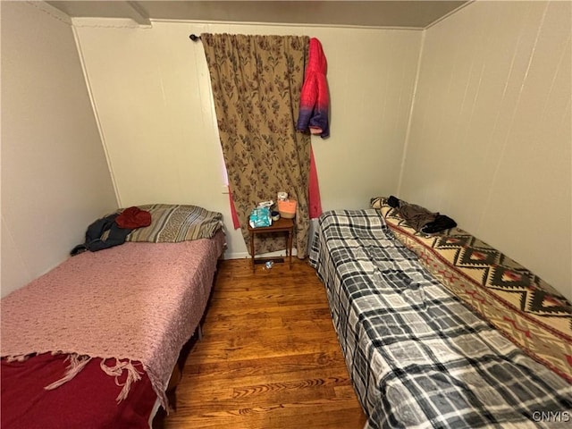 bedroom with dark hardwood / wood-style flooring