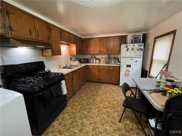 kitchen featuring sink, washer / clothes dryer, and black appliances