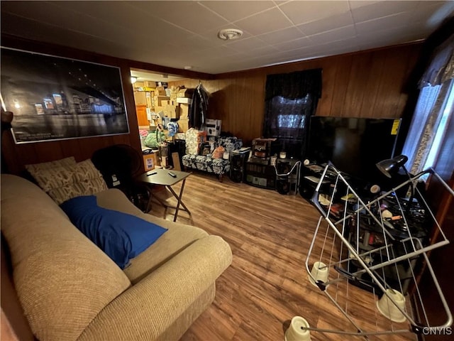 living room with wood walls and hardwood / wood-style floors