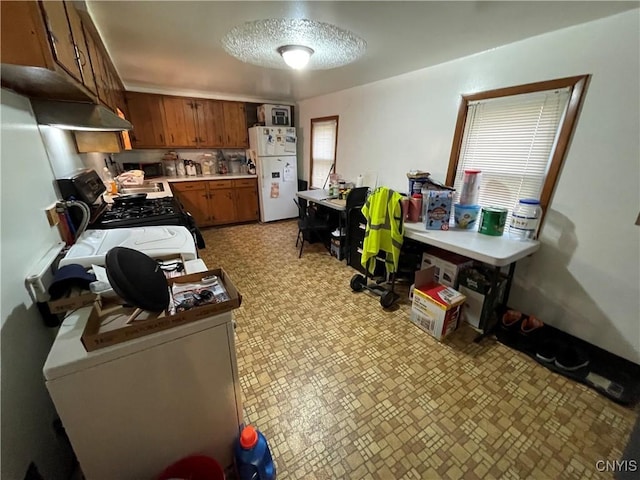 kitchen with white fridge and gas range