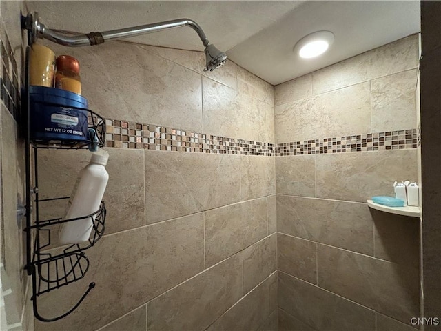 bathroom with a tile shower