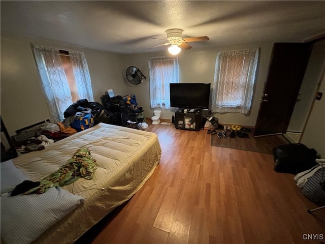 bedroom featuring ceiling fan and light hardwood / wood-style flooring