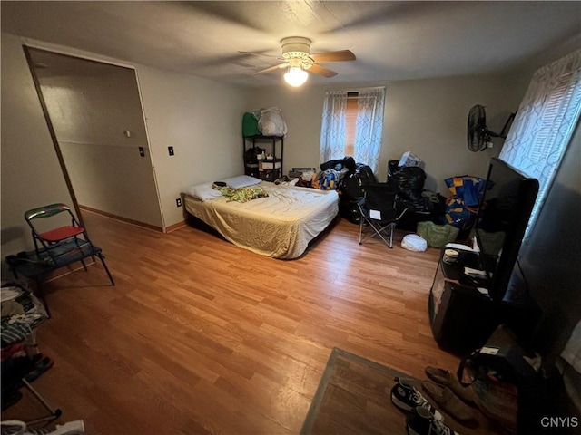 bedroom featuring wood-type flooring and ceiling fan