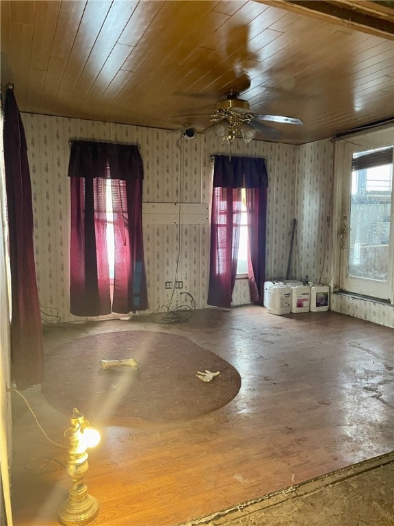 interior space featuring a wealth of natural light, ceiling fan, and wooden ceiling