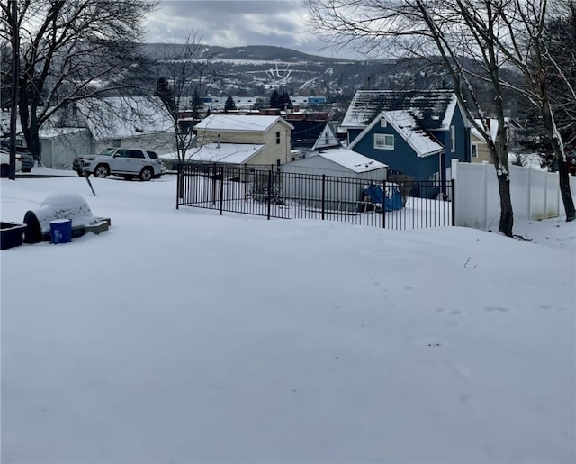 snowy yard featuring a mountain view