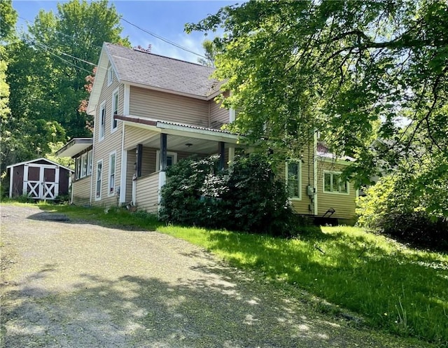 58 Catherine Ln, Hornell, NY 14843 - view of property exterior with a storage shed, an outdoor structure, and roof with shingles