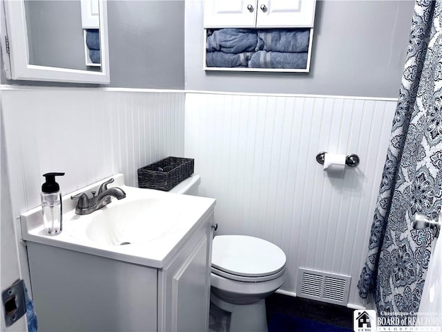 bathroom featuring vanity and toilet