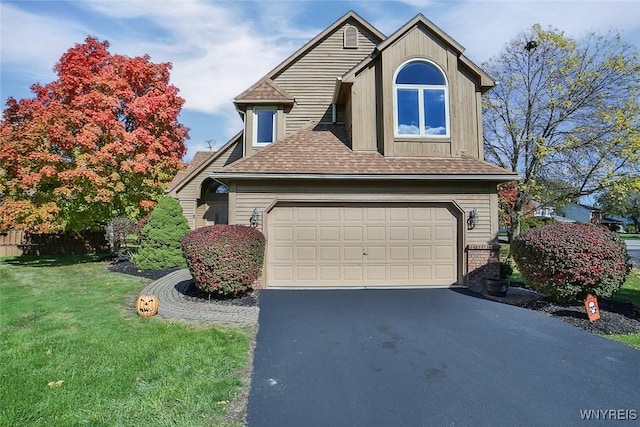 view of front of house featuring a front lawn and a garage