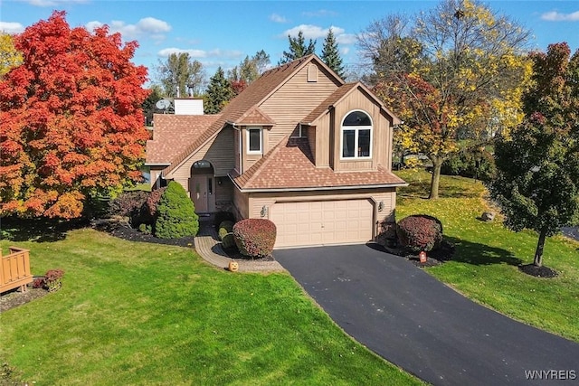 view of front property with a front lawn and a garage