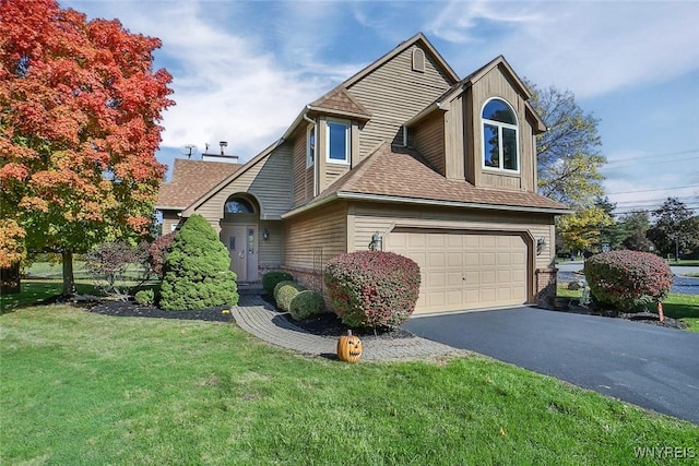 view of front of property with a garage and a front lawn