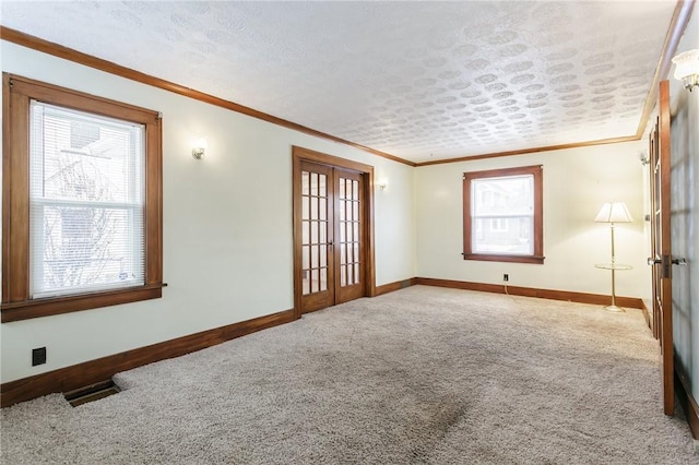 spare room featuring ornamental molding, carpet floors, and french doors