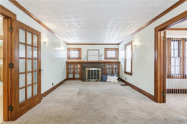 unfurnished living room featuring a fireplace, carpet floors, plenty of natural light, and ornamental molding