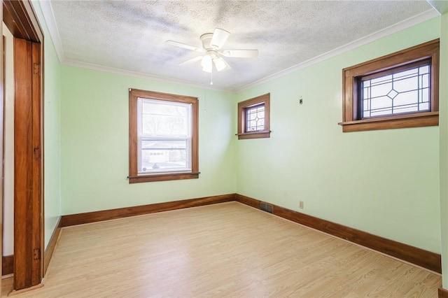 unfurnished room with ceiling fan, light hardwood / wood-style floors, a textured ceiling, and ornamental molding