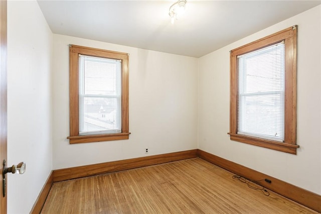 unfurnished room with hardwood / wood-style floors