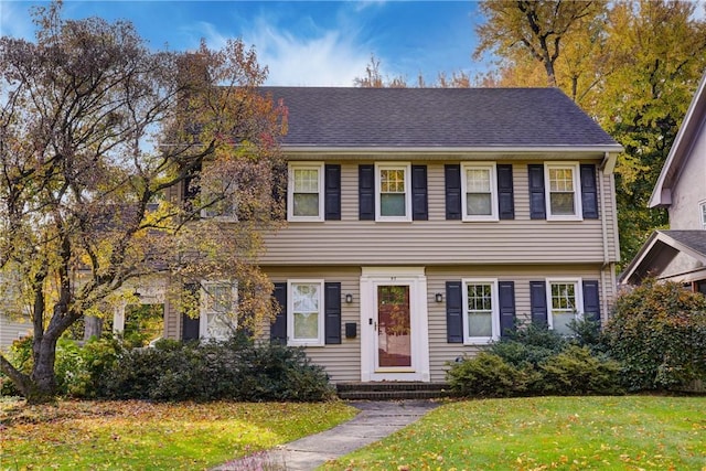 colonial house featuring a front lawn