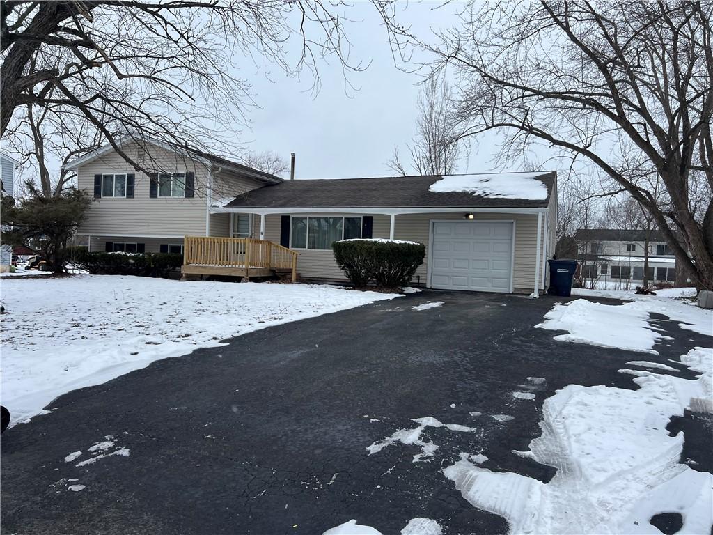 split level home with a garage and a deck