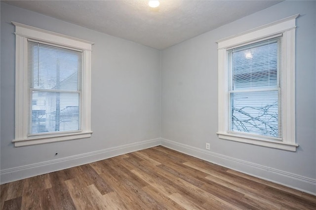 unfurnished room featuring a textured ceiling and hardwood / wood-style flooring