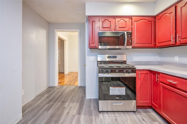 kitchen with light wood-type flooring and appliances with stainless steel finishes